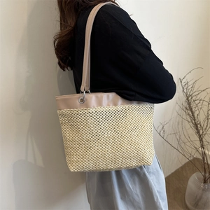 Summer woven straw tote bag with leather trim and shoulder straps for casual beach style