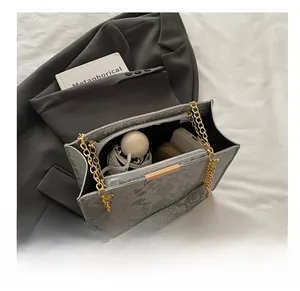 Spacious interior of gray python texture bag showing folding umbrella, phone, and wallet