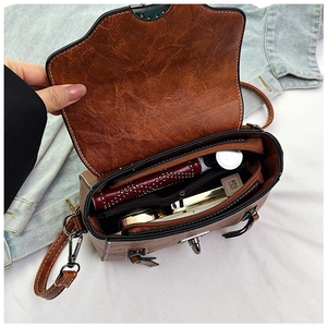 Interior detail of retro brown PU leather crossbody bag showing spacious compartments