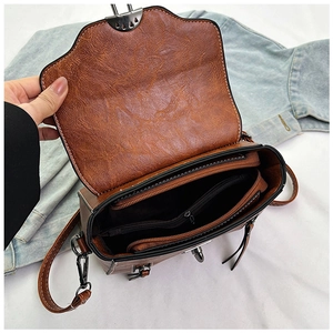 Detailed view of the brown vintage crossbody bag interior with multiple compartments
