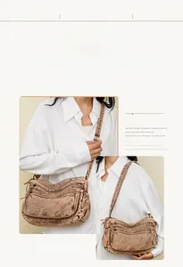 Close-up of vintage brown washed canvas crossbody bag with multi-layer zippers and wide strap
