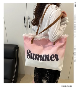 Detail of pink gradient canvas tote bag with fringe edge and leather shoulder strap