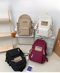 Multi-color minimalist nylon backpacks with front zipper pockets and duck charms