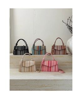 Detailed close-up of woven straw texture and color options for the crossbody bag