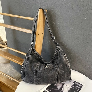 Retro washed denim hobo shoulder bag in black with frayed edges and magnetic snap pocket