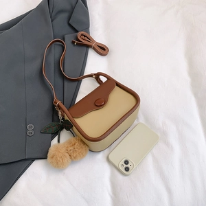 Retro color-block crossbody bag in beige and brown with cherry charm on white background