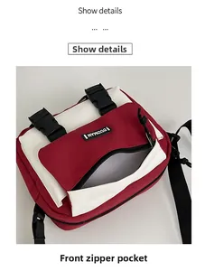 Detail view showing front zipper pocket and buckle closure on canvas crossbody bag
