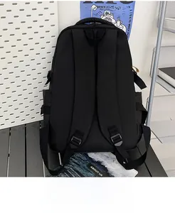 Detail of padded breathable shoulder straps and handle on black canvas backpack