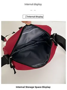 Internal view of the red and white nylon crossbody bag with spacious grey lining storage