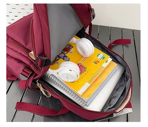 Internal view of burgundy backpack showing large capacity and padded laptop compartment