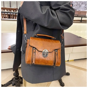 Brown vintage PU leather crossbody bag with metal lock and adjustable strap detail