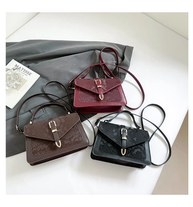 Detailed view of snake-print textured flap bags in burgundy, brown and black leather
