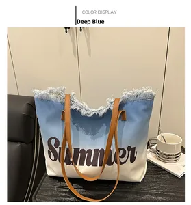 Detail view of large blue and white gradient canvas tote with Summer lettering and fringe