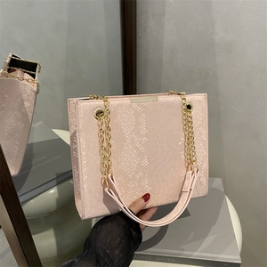 Pink faux snakeskin chain shoulder bag with elegant gold metal details for women