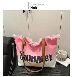 Detail of pink gradient canvas tote bag with fringe edge and black Summer text