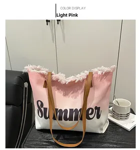 Detail of light pink gradient canvas tote with Summer print and fringe edges