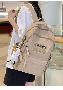 Close-up of beige waterproof nylon backpack featuring multiple pockets and fashion label