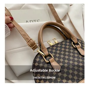 Detail of adjustable buckle and strap connection on stylish brown shell shoulder bag