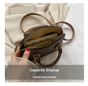 Close-up of retro shell bag showing capacity for a smartphone and a long wallet
