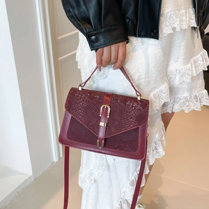 Fashionable burgundy snake pattern handbag with elegant gold metal lock and shoulder strap