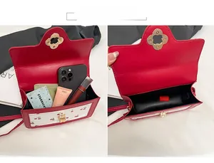 Detail of red cherry print bag showing main pocket capacity for phone and lipstick
