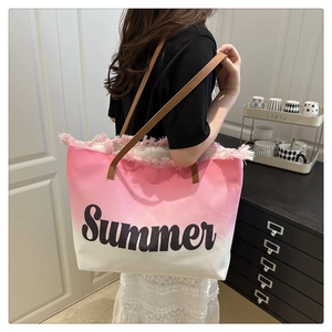 Close-up of pink gradient tote bag with Summer print and fringe detail on the model