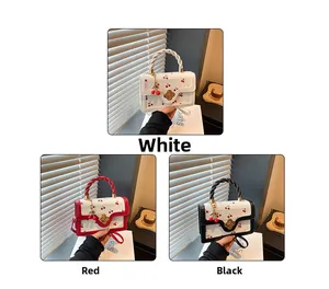 Detailed view of cherry print square handbags with metallic flower buckles in three colors