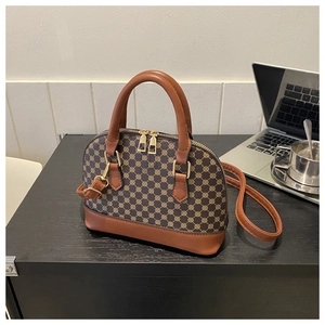 Business style shell bag detail with vintage geometric pattern and caramel leather trim