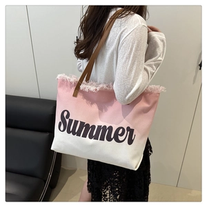 Detail of pink gradient canvas tote bag with fringe edge and Summer lettering