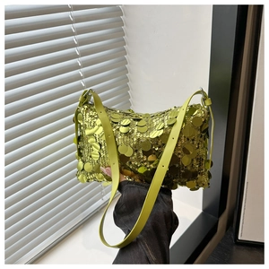 Detail of green sequin shoulder bag showing shimmering texture and leather strap