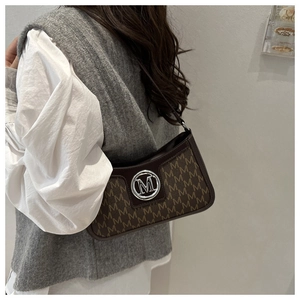 Detail view of the French vintage baguette bag with brown letter print and silver buckle