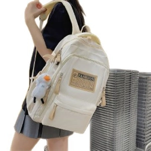 Minimalist beige high-capacity school backpack with a cute duck charm for students