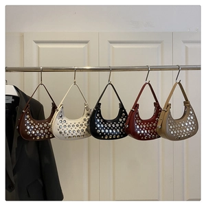 Detail view of five colors of leather crescent hobo bags with silver rivet embellishments