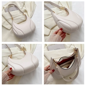Detail views of off-white crescent bag with 3D rib texture and vibrant red lining interior
