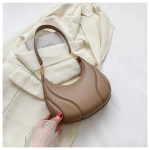 Detailed close-up of textured hobo bag leather with elegant gold metal buckles