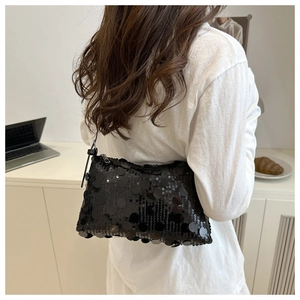 Close-up of black sequined shoulder bag with shimmering texture for evening parties