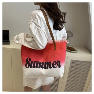 Detail of canvas tote bag with red gradient, pink fringe trim and Summer text print