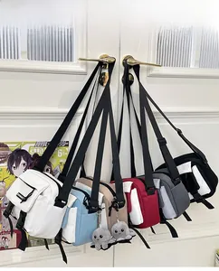 Detail of six colorful nylon mini crossbody bags with buckle closure and plush octopus charms