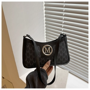 Close-up of black retro underarm bag with grey M letter print and silver metal logo