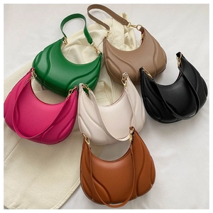 Flat lay of half-moon underarm bags in six colors with wave quilted leather texture