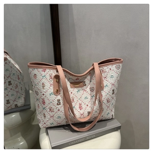 Detailed view of large tote bag featuring cute cartoon bear print and pink shoulder straps