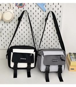 Close-up of canvas messenger bags with dual buckle pockets and adjustable straps