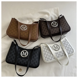Macro detail of monogram vintage underarm bags in four colors with round metal hardware