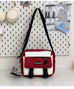 Canvas messenger bag in red and white with a cute grey octopus plush toy keychain