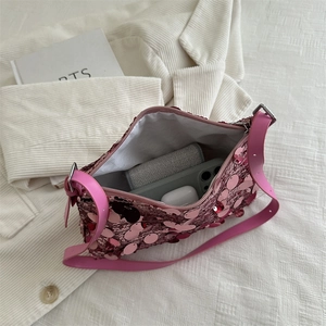 Pink sequin shoulder bag showing internal storage for phone and wireless earbuds
