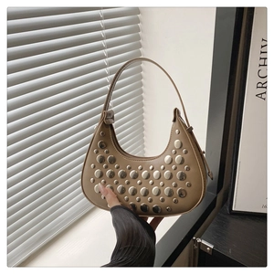 Detail of khaki crescent hobo bag with silver metallic studs and matte leather finish
