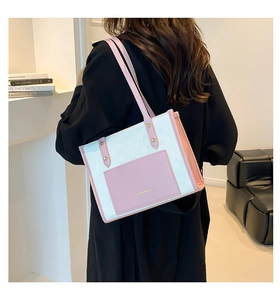 Pink and white contrasting tote bag shown on shoulder in a minimalist indoor setting