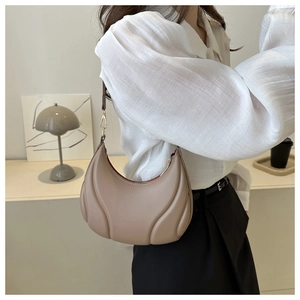 Fashionable moon-shaped underarm bag with textured quilted lines in apricot leather