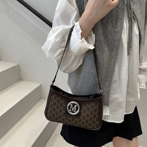 French vintage underarm bag with brown leather, M-letter print, and silver metal buckle