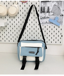 Detail of canvas messenger bag with contrast stitching and adjustable nylon strap